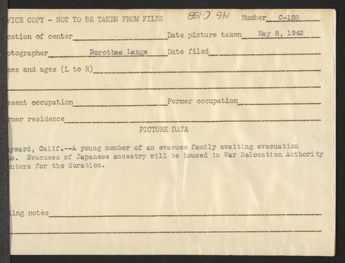 Hayward, Calif.--A young member of an evacuee family awaiting evacuation bus. Evacuees of Japanese ancestry will be housed in War Relocation Authority centers for the duration. Photographer: Lange, Dorothea Hayward, California