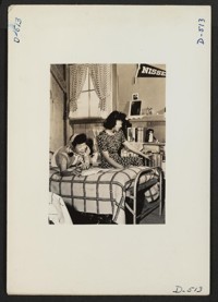 Manzanar, Calif.--Oko Murata (left), and Esther Naito, office workers from Los Angeles, in their quarters at Manzanar, a War Relocation