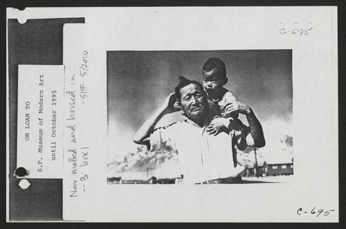 Manzanar, Calif.--Grandfather and grandson of Japanese ancestry at this War Relocation Authority center. Photographer: Lange, Dorothea Manzanar, California