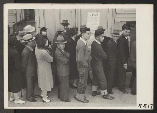 In response to the Army's Exclusion Order No. 20, residents of Japanese ancestry appear at Civil Control Station at 2031 Bush Street, for registration. The evacuees will be housed in War Relocation Authority centers for the duration. Photographer: Lange, Dorothea San Francisco, California