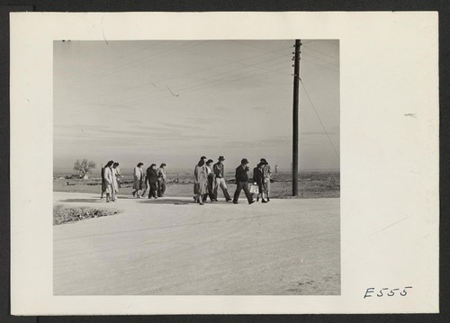 5:00 P.M. and the administrative office workers trek home to their barracks. Photographer: Parker, Tom Amache, Colorado