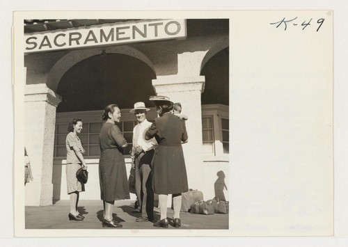 Returnees from the Rohwer Relocation Center awaiting transportation to their homes in Sacramento. Roaring into Sacramento Monday morning, July 30