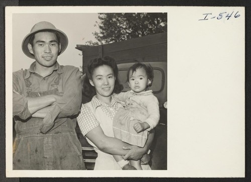 Shibo Hayashi, his wife Kimiye, and daughter Kuye formerly of Rohwer and San Pedro, California, stand by the truck which