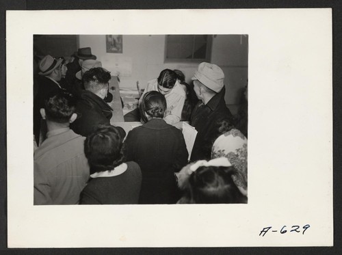 Absentee voters of Japanese descent getting ballots and having them notarized. Photographer: Stewart, Francis Newell, California