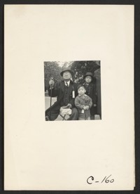 Hayward, Calif.--Grandfather and grandchildren awaiting evacuation bus. The grandfather conducted a dyeing and cleaning business. The family unit is preserved