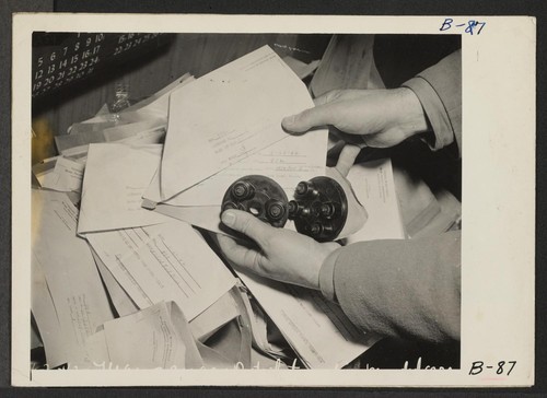 Manzanar, Calif.--Distributor of one of the 150 impounded automobiles owned by evacuees of Japanese ancestry assigned to this War Relocation Authority center. These distributors are kept in Administration building. Photographer: Albers, Clem Manzanar, California