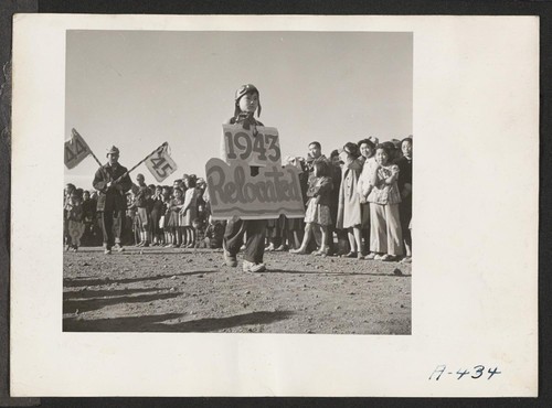 Two of the participants of the Harvest Festival parade, which was witnessed by a large crowd of the residents at this relocation center. Photographer: Stewart, Francis Newell, California