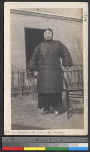 Woman in padded clothing standing outdoors, Jiangsu, China, ca.1905