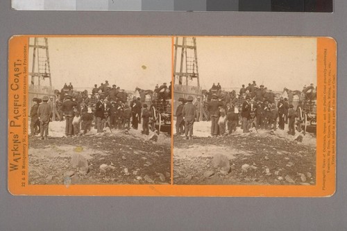 [Crowd of men, boys, and wagons near a tall wooden structure. Possibly Telegraph Hill or the Russian Hill Observatory, San Francisco?]