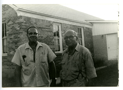 Herman Bousley and William Watts standing out of C.M.E. church, Lodi, Texas