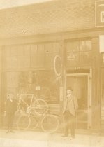 Two men posing in front of Stern's Bicycles