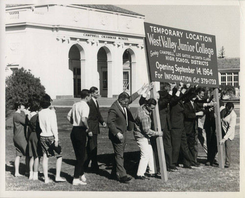 Raising temporary location sign for West Valley Junior College at Campbell Grammar School location, 1964