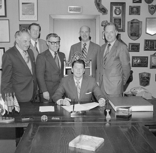 Governor Reagan signing bill with Board members