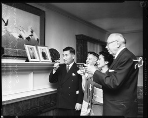 2 images. Emperor Hirohito's birthday, 29 April 1955. Shinsaker Hogen (Consul General); Mrs. Margaret Winder; Mrs. Yasuko Hogen; Mayor Clarence Winder (Toasting picture of Emperor and Empress)