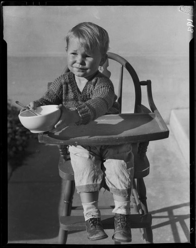 Child in highchair with bowl, Los Angeles, circa 1935