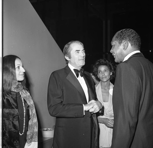 Tom Bradley talking with Gregory and Veronique Peck at an event in Bradley's honor, Los Angeles, 1974