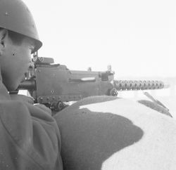 Trainee aiming .30 caliber machine gun at Fort Ord — Calisphere