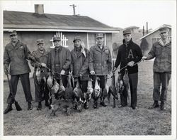 General James Van Fleet posing with hunting party and game