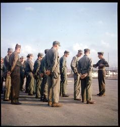 Soldiers gathered and listening to sergeant with clipboard