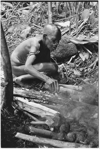Boori'au and another woman cook taro