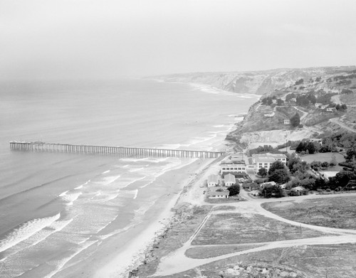 Scripps Institution of Oceanography shown here in an aerial view facing north towards the pier and cliffs. August 1949