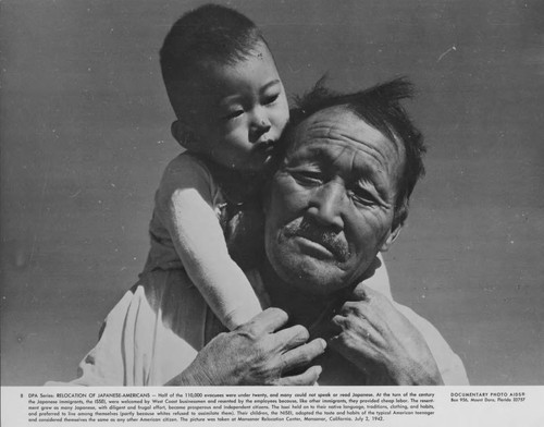 [Man and child at Manzanar incarceration camp]