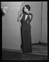 Woman models a dark, satiny dress the Times' fashion show, Los Angeles, 1935