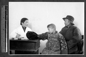 Father and son with social worker, Jinan, Shandong, China, 1941