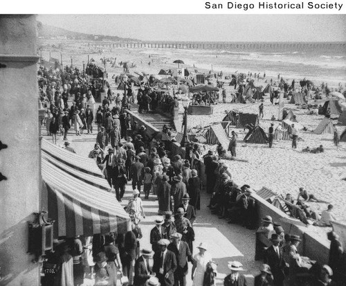 People gathered on Mission Beach boardwalk