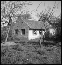 [Artist / sculptor Henri Edouard Navarre outside country cottage and ceramics studio]