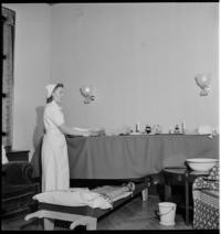 1st Day War. 2:15 Nov. 30th. Nurse. "Grand piano becomes dressing table." [Hotel Kamp, press headquarters turned air raid station]