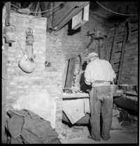 Lisieux. Bakery interior. [Man working inside; presumably Boulangerie / Patisserie H. Verdier]