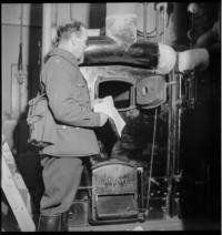 1st Day War. Burning papers [Government Palace? Soldier putting papers in furnace. Papers of State being burned, Ministry of Foreign Affiars, 1:30 P.M.]