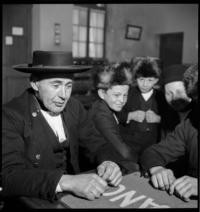 Foyer D.C.A. Card player [Men and boys in Alsatian dress]