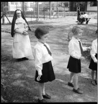 [Children at school. Nun with children playing outside]