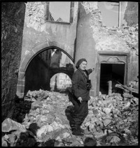 [Ammerschwihr: TB Village. Thérèse Bonney pointing among ruins and rubble.]