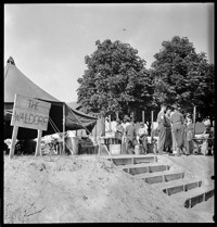 [Recovered Allied Military Personnel, RAMPs: "The Waldorf" sign on tent in camp for (former?) P.O.W.s]