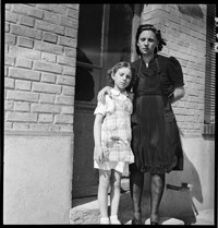 [Reims: Bourgogne. Mmme. Gauin[?] with daughter at door of Cafe de la Gare]