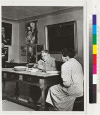 [Gertrude Stein with Alice B. Toklas seated at a table.]