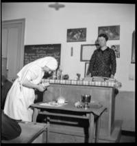 School nurse. Teacher and nurse [Nurse preparing medicine in classroom]