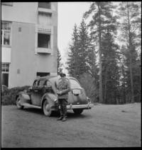 1Bad Grankulla. 11:00 a.m. Car of the American Minister, Evacuated American Legation Headquarters, Bad Grankulla [Man in uniform next to car outside building]