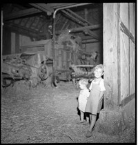 Miscellaneous Children: [boy and small girl at barn entrance.]