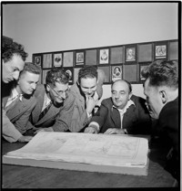 [Neyrpic Printed: "Danel collaborations", with young men viewing map]