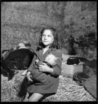 Mouchy: May 25 Features. Child with doll [Refugees. Mouchy le Chatel, France]