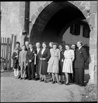 [Miscellaneous People: group portrait under stone arch over road]