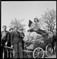 [Freed French prisoners(?) on road, with typical German cart, displaying a French flag.] (Filed with "Prisoners Arrival Le Bourget" series.)