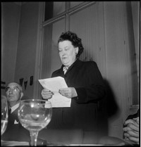 [Thérèse Bonney in France: Bonney reading a speech at a table]
