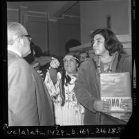 Two Native American Indian protesters talking to Dr. Carl Dentzel, director of Southwest Museum about display in Los Angeles, Calif., 1970