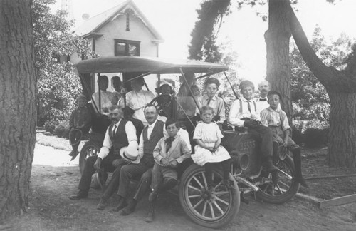 Dittmer, Eltiste and Blank families seated on 1910 Ford Model T automobile at Eltiste Ranch in Orange, California, ca. 1910