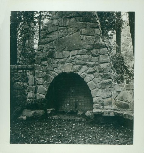 Large outdoor stone hearth with attached stone bench